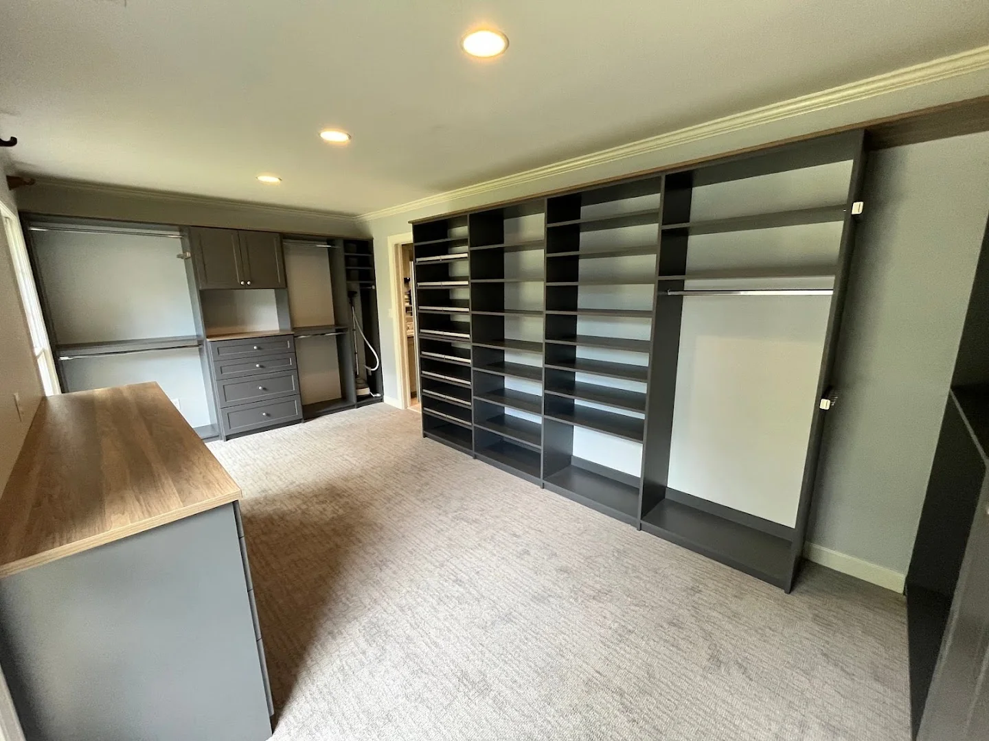 Dark wall-to-wall shoe and clothing storage