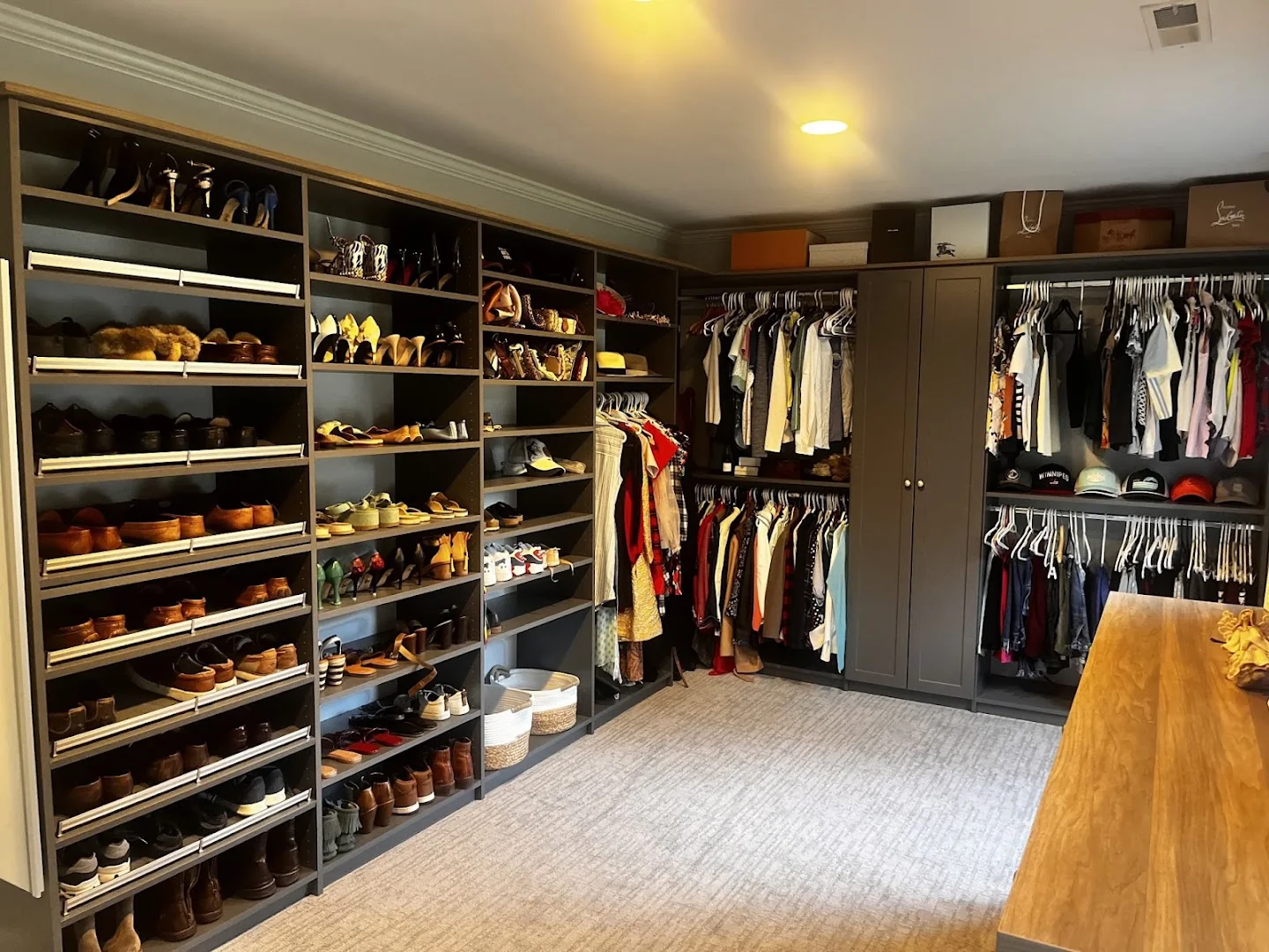 Dark walk-in closet with organized hanging zones